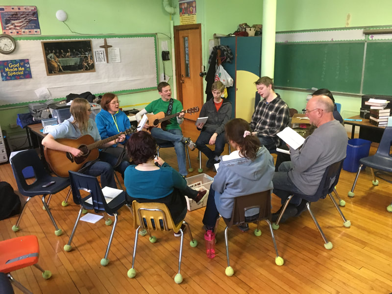 
Participants learn new songs while others practice a drama.